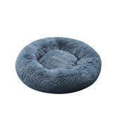 Blue fluffy donut pet bed on a white background