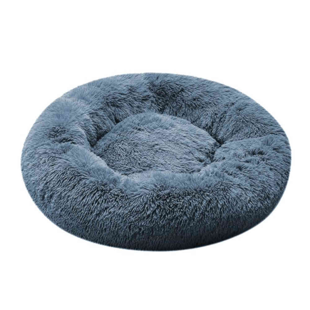 Round, fluffy pet bed in a light blue color on a white background