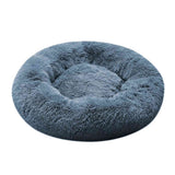 Round, fluffy pet bed in a light blue color on a white background